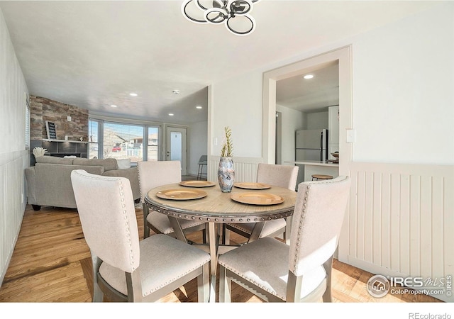 dining space with recessed lighting and light wood finished floors