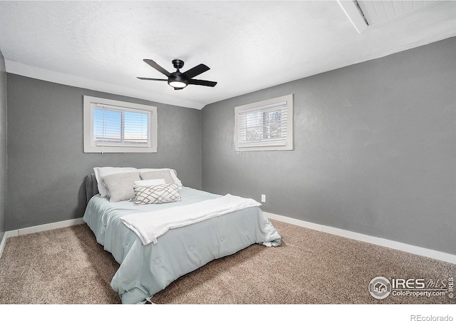 bedroom with multiple windows, carpet, and baseboards