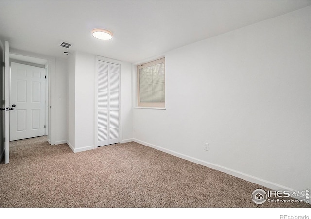 unfurnished bedroom with a closet, carpet flooring, visible vents, and baseboards