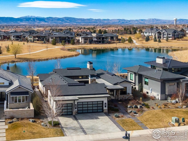 aerial view featuring a residential view and a water and mountain view