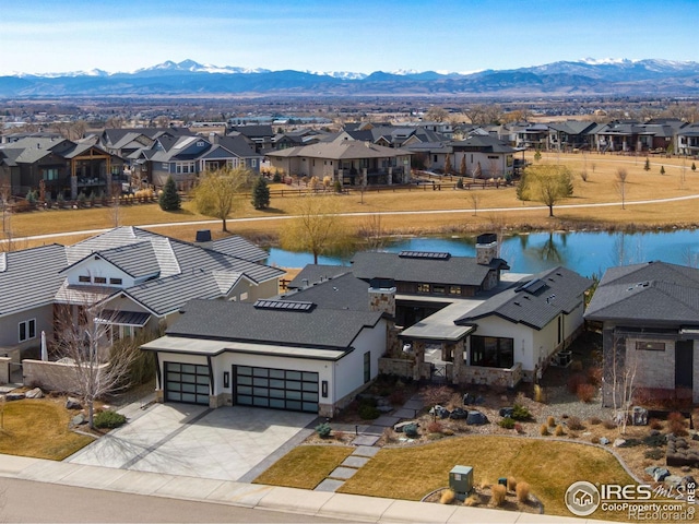 aerial view featuring a residential view and a water and mountain view