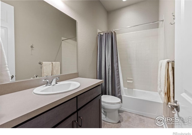 full bath featuring vanity, shower / bath combo, tile patterned flooring, toilet, and a textured wall