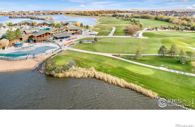 birds eye view of property with a water view and golf course view