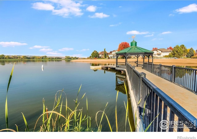 view of dock with a gazebo and a water view