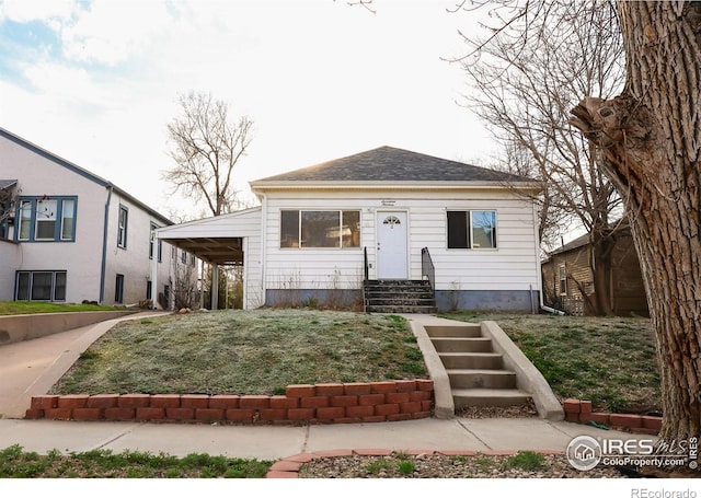 bungalow-style house with entry steps and a front lawn