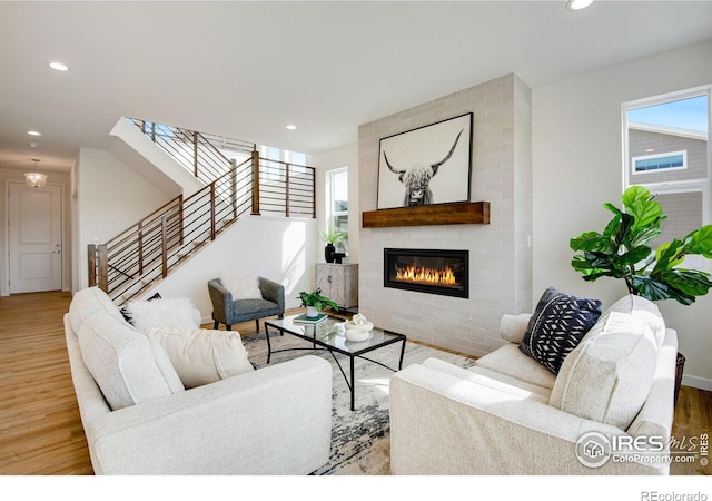 living room featuring recessed lighting, wood finished floors, and plenty of natural light