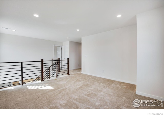 carpeted spare room with recessed lighting and baseboards