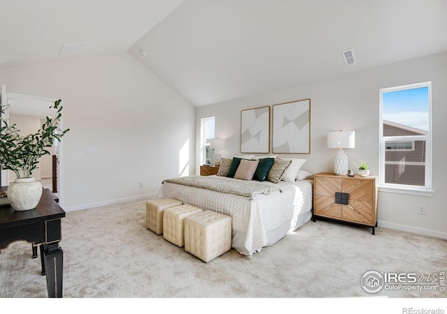 carpeted bedroom with lofted ceiling, baseboards, and visible vents