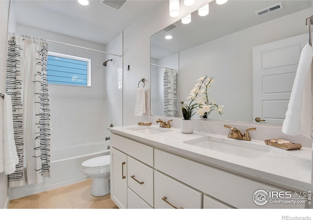 bathroom featuring tile patterned flooring, shower / bath combination with curtain, visible vents, and a sink