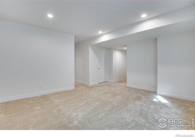 finished basement featuring light carpet, recessed lighting, and baseboards