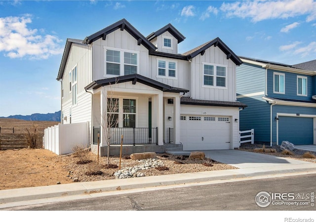 view of front of house with a garage, covered porch, board and batten siding, and driveway