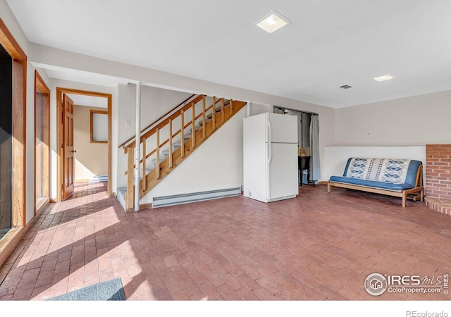 15 Golden Age Rd, Jamestown, CO 80455 - basement with baseboard heating, freestanding refrigerator, brick flooring, and stairway