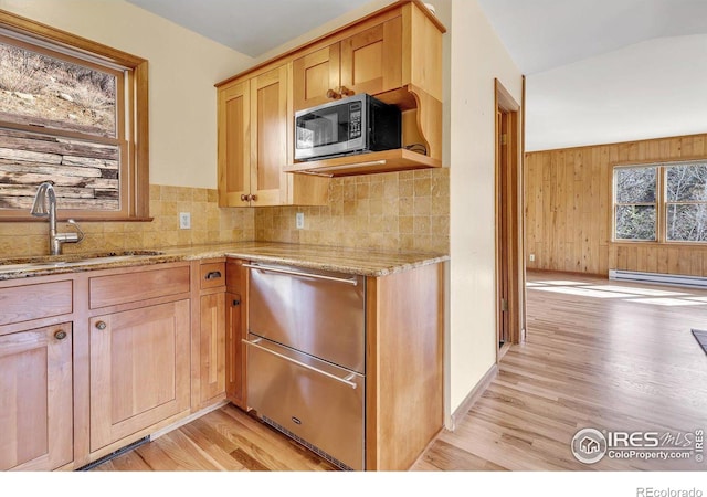 15 Golden Age Rd, Jamestown, CO 80455 - kitchen featuring appliances with stainless steel finishes, a baseboard radiator, light wood-style floors, light stone counters, and decorative backsplash