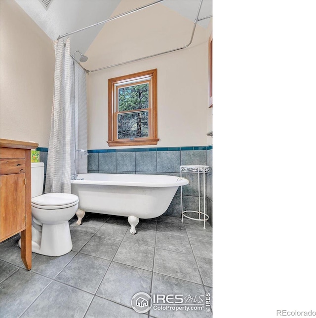 15 Golden Age Rd, Jamestown, CO 80455 - bathroom with tile patterned flooring, tile walls, a wainscoted wall, and vaulted ceiling