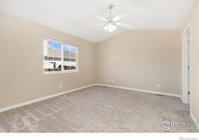 empty room featuring baseboards, a ceiling fan, carpet, and vaulted ceiling