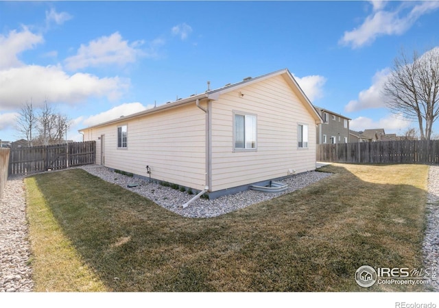 view of property exterior featuring a fenced backyard and a lawn