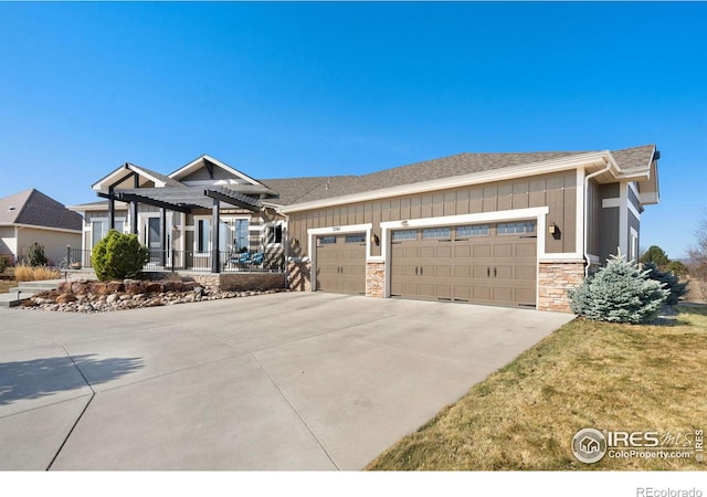 view of front of property with a pergola, a garage, board and batten siding, and concrete driveway