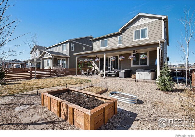 back of property with a patio area, fence, and a garden