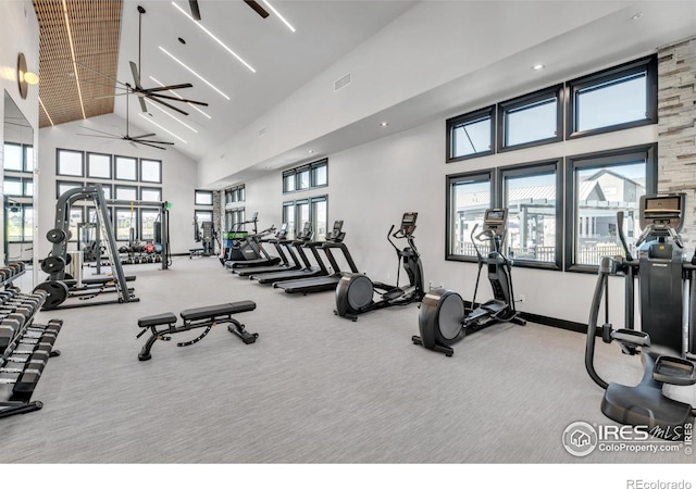 gym featuring visible vents, carpet floors, high vaulted ceiling, and baseboards