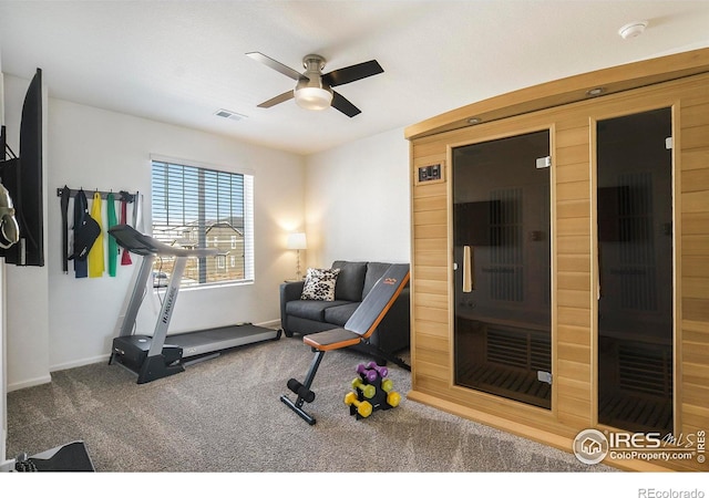 exercise area featuring visible vents, a ceiling fan, a sauna, carpet flooring, and baseboards