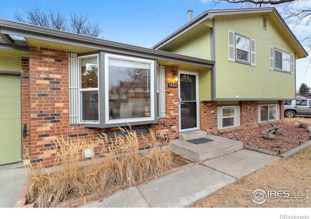 split level home with brick siding