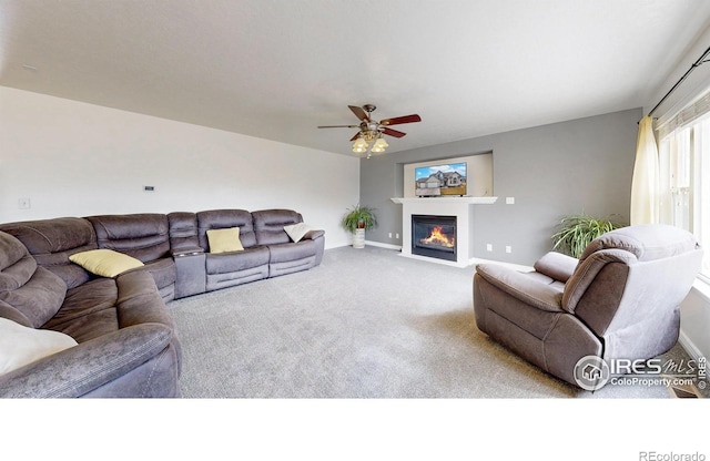 1386 Plains Ct, Eaton, CO 80615 - carpeted living room with a fireplace with flush hearth, a ceiling fan, and baseboards