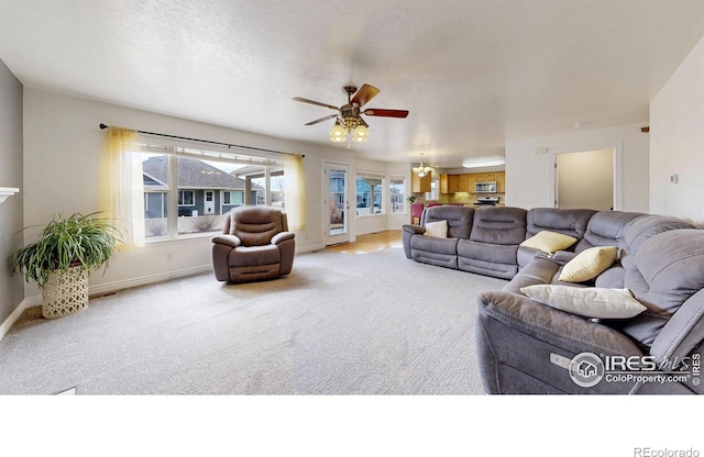 1386 Plains Ct, Eaton, CO 80615 - carpeted living room with ceiling fan with notable chandelier, baseboards, and a textured ceiling