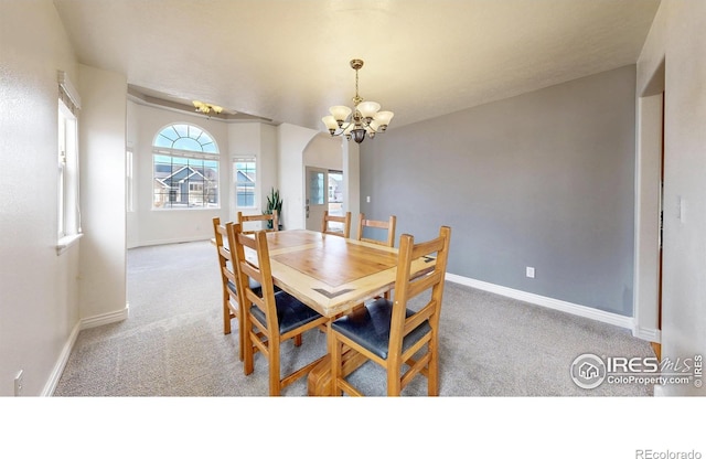 1386 Plains Ct, Eaton, CO 80615 - dining room with a notable chandelier, arched walkways, baseboards, and carpet floors