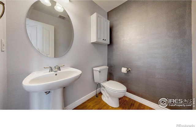 1386 Plains Ct, Eaton, CO 80615 - half bathroom with visible vents, toilet, wood finished floors, and baseboards