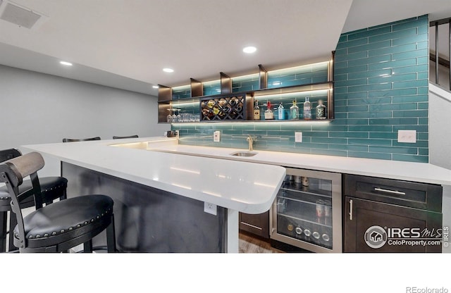1386 Plains Ct, Eaton, CO 80615 - bar featuring visible vents, beverage cooler, backsplash, recessed lighting, and indoor wet bar