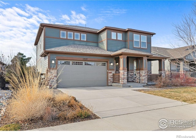 view of front of property featuring stone siding, covered porch, an attached garage, and concrete driveway