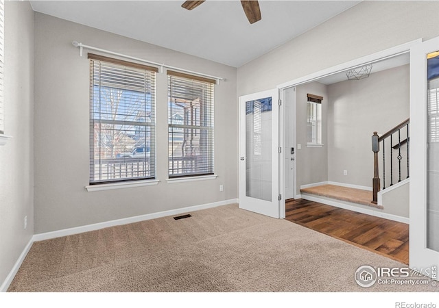 interior space with visible vents, stairway, and baseboards