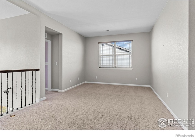 spare room with carpet flooring and baseboards