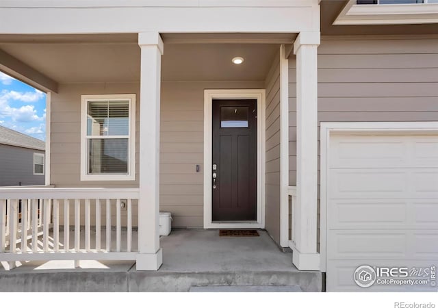 entrance to property with a porch and a garage