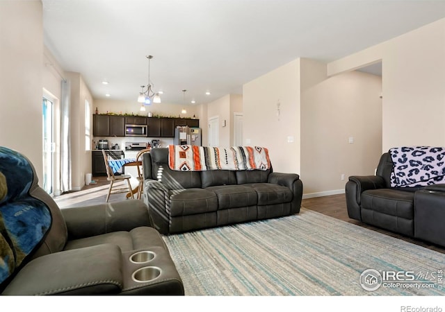 living area with recessed lighting, baseboards, and wood finished floors