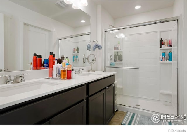 bathroom with a sink, visible vents, and a stall shower