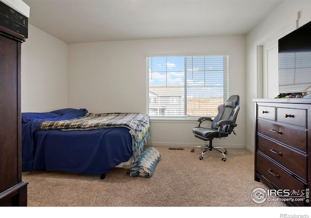 bedroom featuring carpet flooring, visible vents, and baseboards