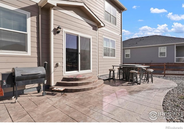 view of patio with fence, area for grilling, and entry steps