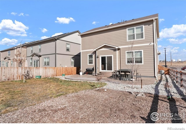 back of house featuring a fenced backyard, entry steps, and a patio