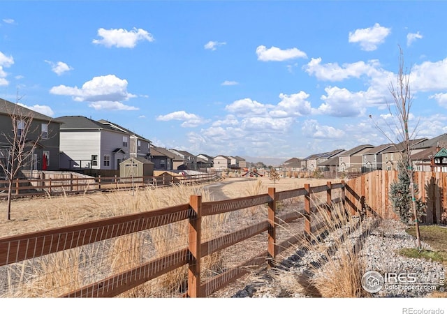 view of yard featuring a residential view and a fenced backyard