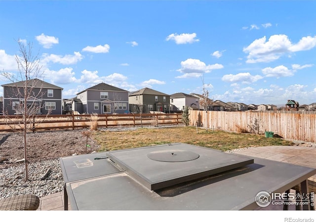 view of yard featuring a residential view, a patio, and fence