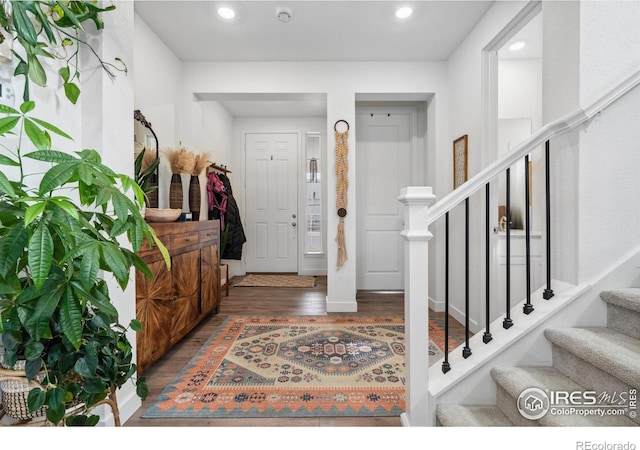 foyer with stairs, recessed lighting, and wood finished floors