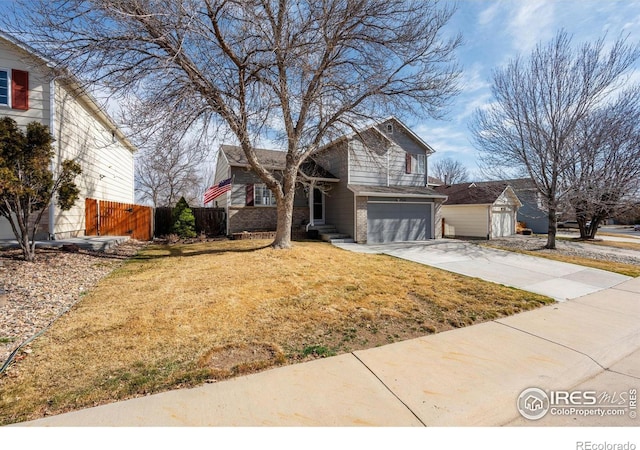 view of front facade featuring fence, an attached garage, concrete driveway, a front lawn, and brick siding