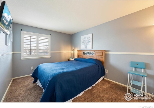 bedroom featuring carpet and baseboards