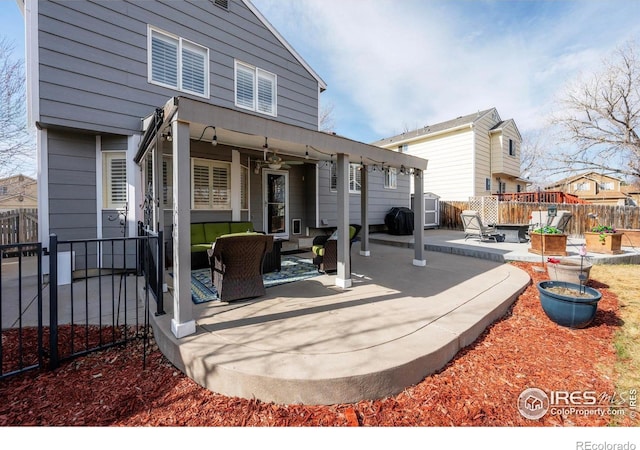 exterior space featuring outdoor lounge area, a patio area, a fenced backyard, and ceiling fan