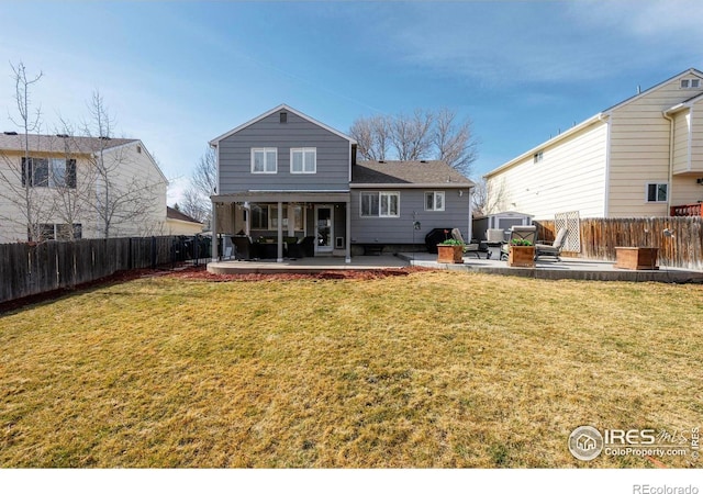 back of house with a yard, a patio, and a fenced backyard