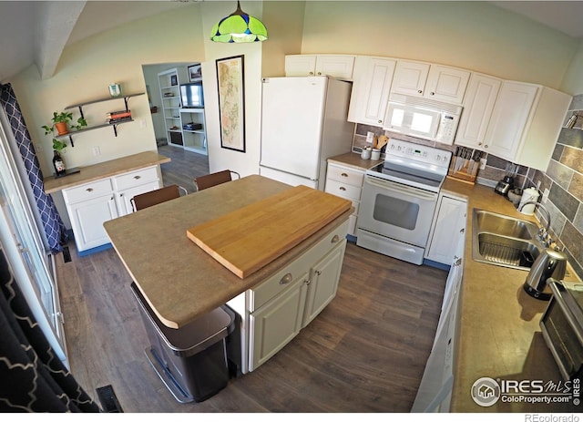 kitchen featuring dark wood-style floors, white cabinets, white appliances, and a sink