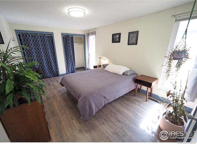 bedroom featuring a textured ceiling and wood finished floors