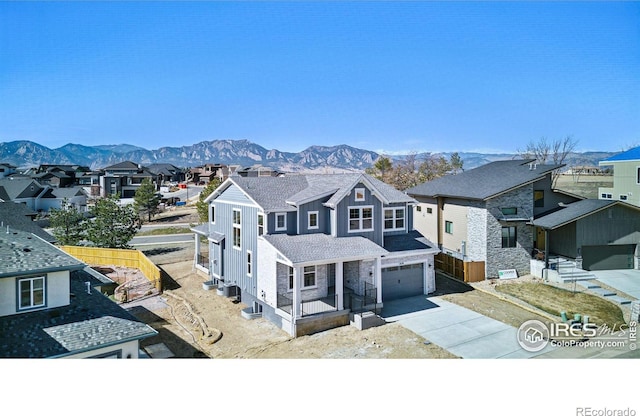view of front facade with a residential view, an attached garage, and driveway