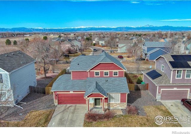 birds eye view of property with a mountain view and a residential view